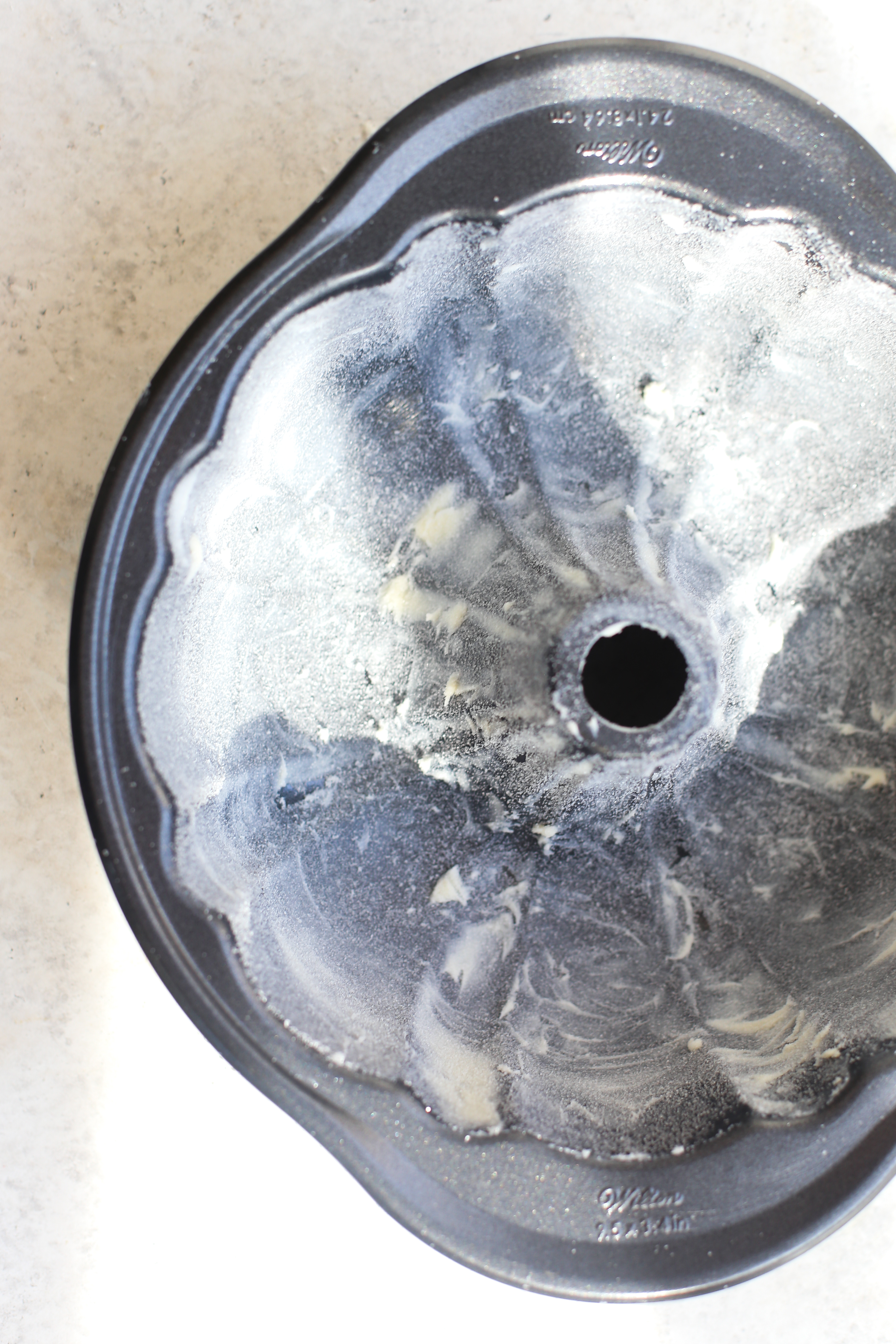 Lemon Bundt Cake Showing Sugared Buttered Bundt Pan