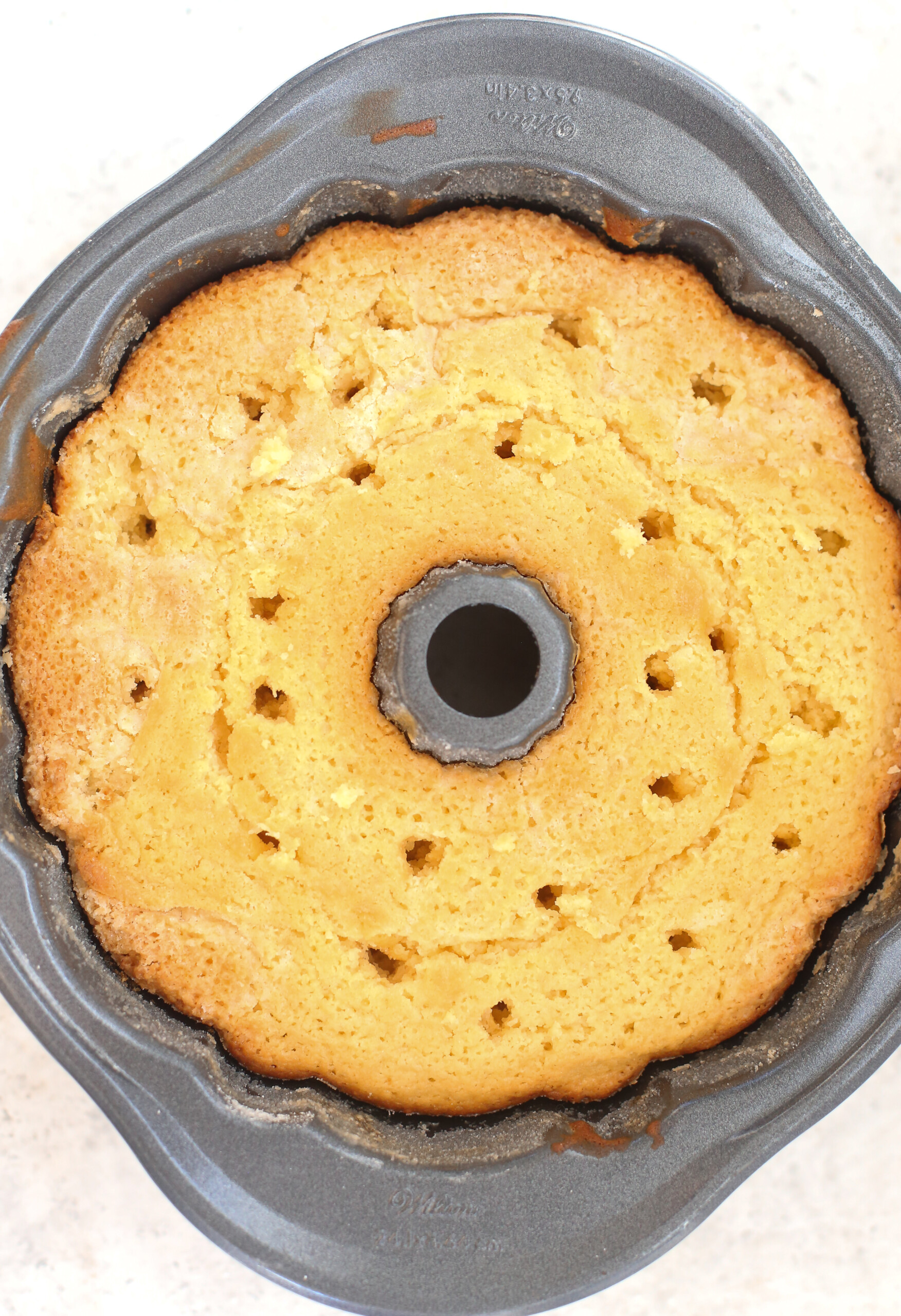 Lemon bundt cake showing poke holes